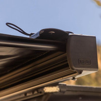 ARB Hard Case Awning with Light, close-up of the black hard case mounted on vehicle roof with LED light and branded ARB logo visible.