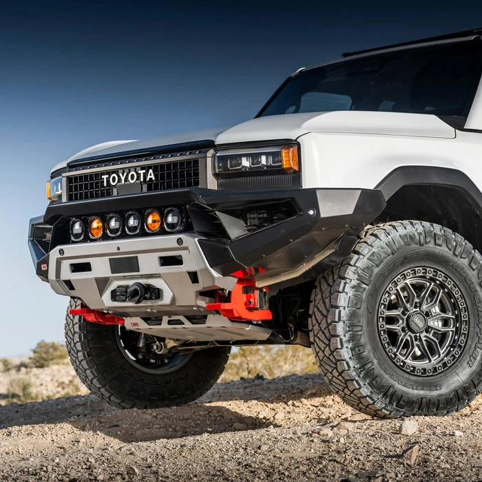 ARB Zenith Winch Bumper for Toyota Land Cruiser 2024+, rugged off-road vehicle with durable black and silver bumper, large off-road tires, and front-mounted winch for enhanced off-road performance.
