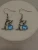 Silver-tone Dolphin Dangle Earring Feature a Blue Stone and Small Crystals