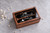 Personalized walnut wedding ring box with clear glass lid, featuring custom UV-printed names and wedding date. This wooden quad ring holder has a black velvet interior that holds 2–4 rings, making it ideal for wedding ceremonies, ring bearers, and personalized wedding keepsakes.