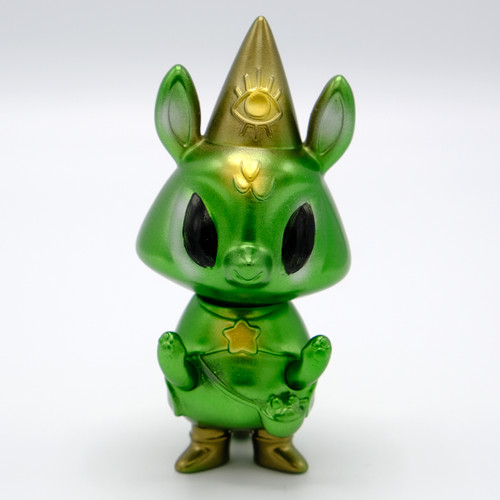 A green animal figure wearing a gold pointed hat