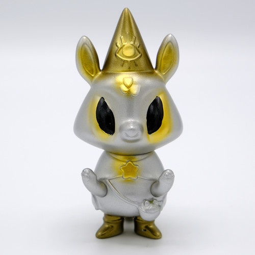 A silver animal wearing a gold pointed hart