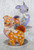 Orange and purple animals wearing bows displayed on plates