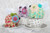 Three multicolored animals displayed on tea cups
