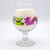 Drinking glass with characters printed on it.