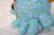 A close up of a round blue animal sculpture with many legs
