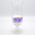 Drinking glass with a purple design printed on it. Text reads, 'by Horrible Adorables.'