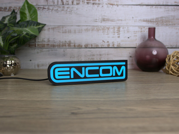 Celebrate your love for TRON with the ENCOM logo LED sign! Eco-friendly and stylish, it's the perfect addition to your gaming setup or home decor.