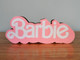 Embrace the magic of the Barbie Movie with this LED illuminated logo. A unique collectible for fans, made from biodegradable materials and powered by USB.