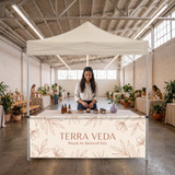 Custom tent half wall on a skincare founder's ten foot booth at an indoor pop-up market.