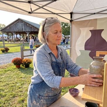 Custom craft fair canopy tent with printed walls at a pottery booth