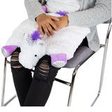 Unicorn Lap Pad on top of girl's lap with hands petting the cover.