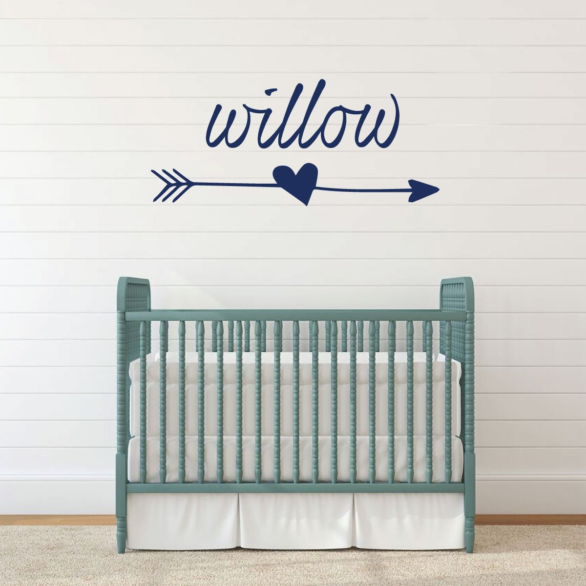 Personalized baby name Willow with heart and arrow wall decal above a sage green crib