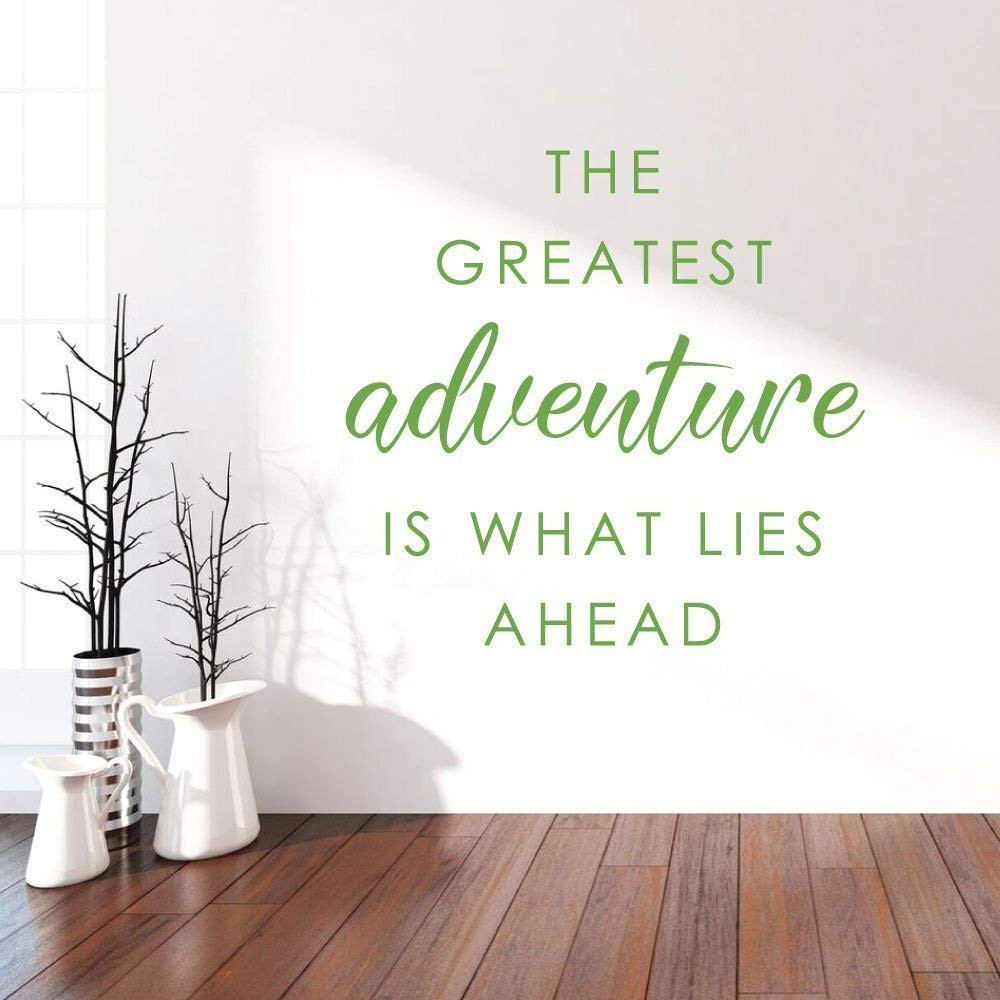 The Greatest Adventure Is What Lies Ahead vinyl wall decal in a sunlit modern living room