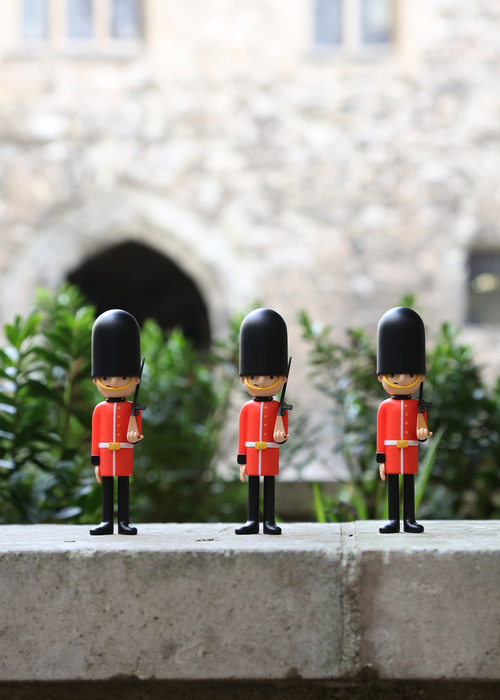 three london art toy guards standing in a row