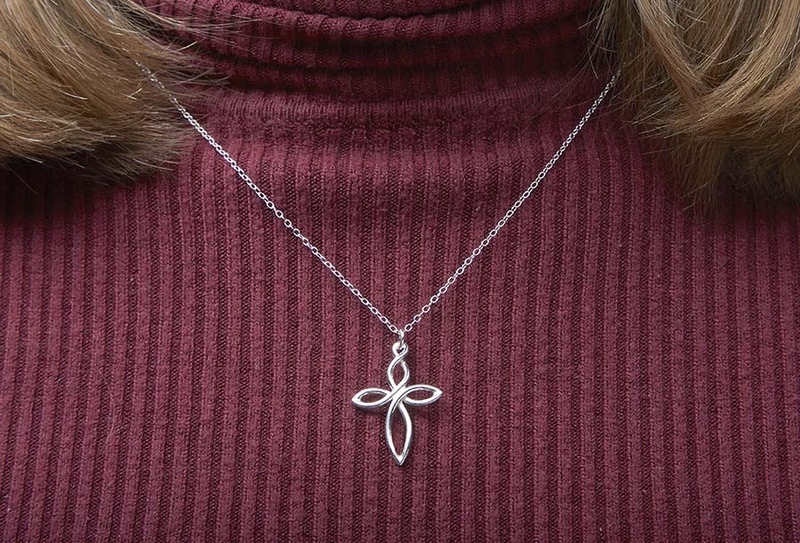 A necklace of a cross in spiral twisted shape in silver
