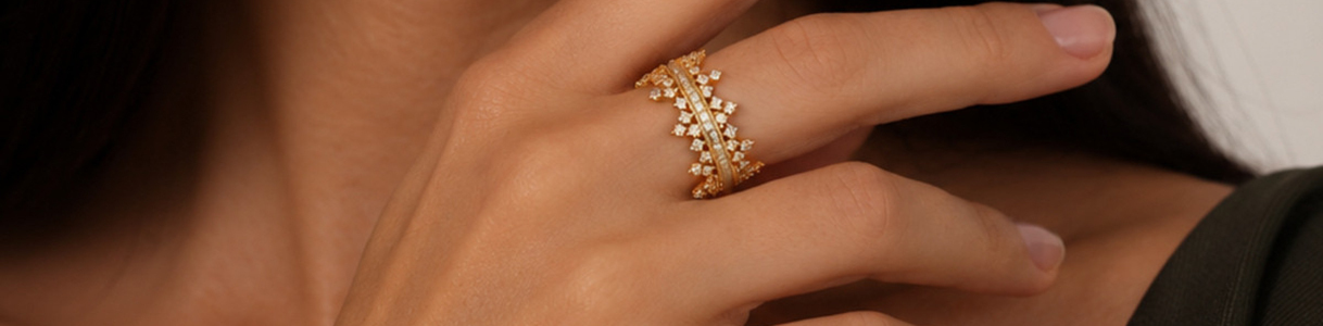 A woman with a crown ring on her finger