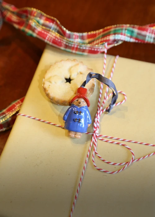 A paddington bear decoration on a present with a mince pie