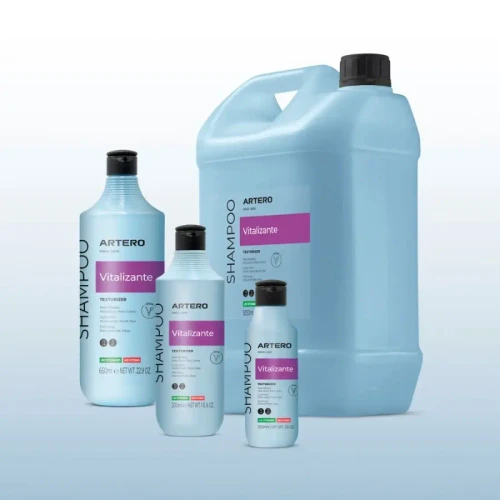 Artero Vitalizante Shampoo, set of four bottles and large container of revitalizing hair shampoo for professional use with light blue packaging and pink label.