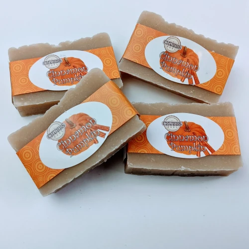 Chubbs Bar Cinnamon Pumpkin - 4oz, four beige cinnamon pumpkin soap bars with orange patterned labels arranged on a white surface.