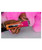 Andis ProClip® 5-in-1 Sunset Clipper, pink grooming clipper being used to trim a fluffy pink pet.