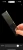 Colin Taylor Products Colin Taylor Panda Combi Comb in Gun Metal Grey - metal hair comb with fine teeth, brand name engraved, held by hand against a black background.