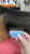 Zolitta Set of 5 Skip Tooth Wide Attachment Combs, close-up of a wide toothed comb being used on a person's hair in a hair salon.