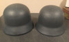 Pair of metal reproduction German military helmets with liners