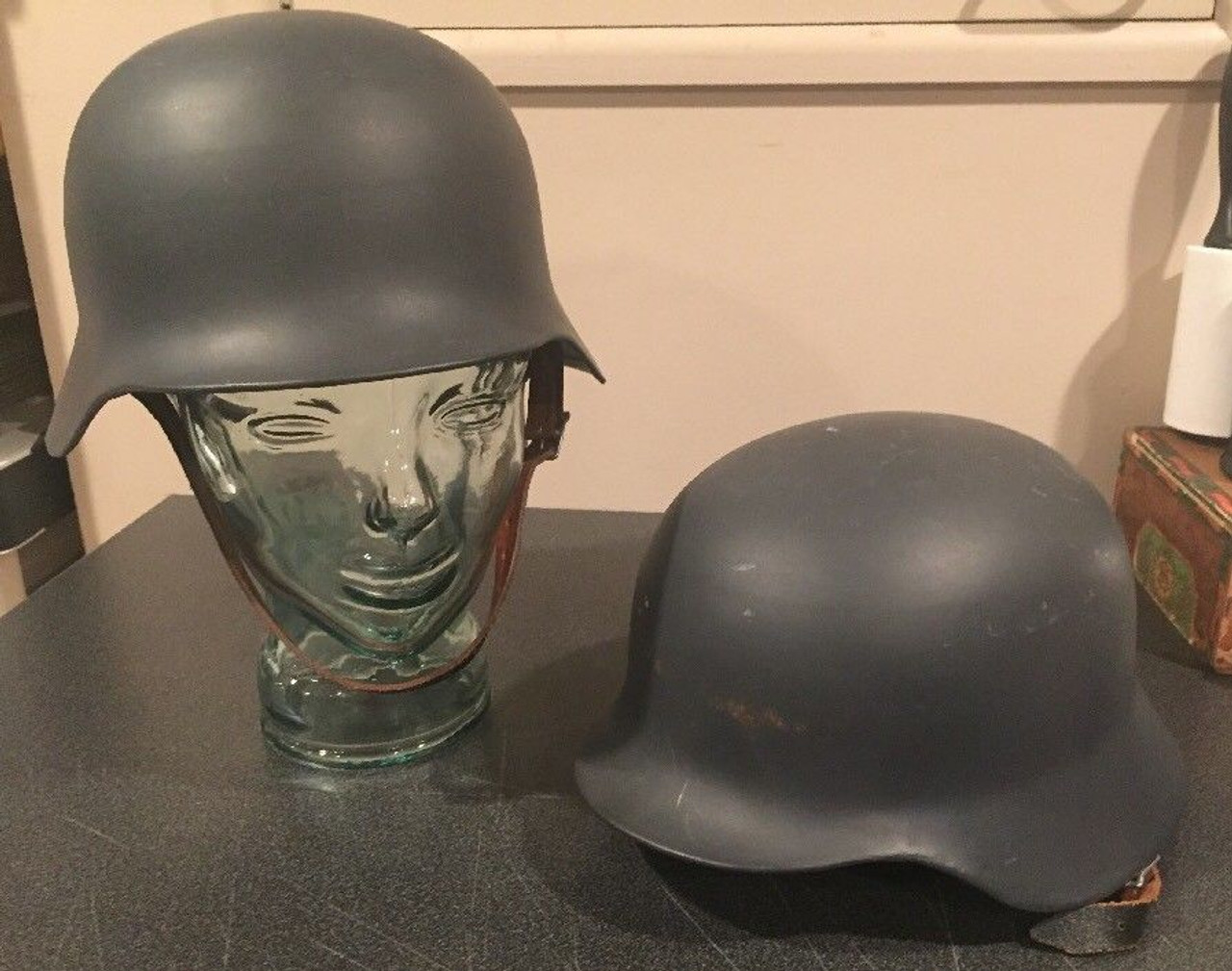 Pair of metal reproduction German military helmets with liners