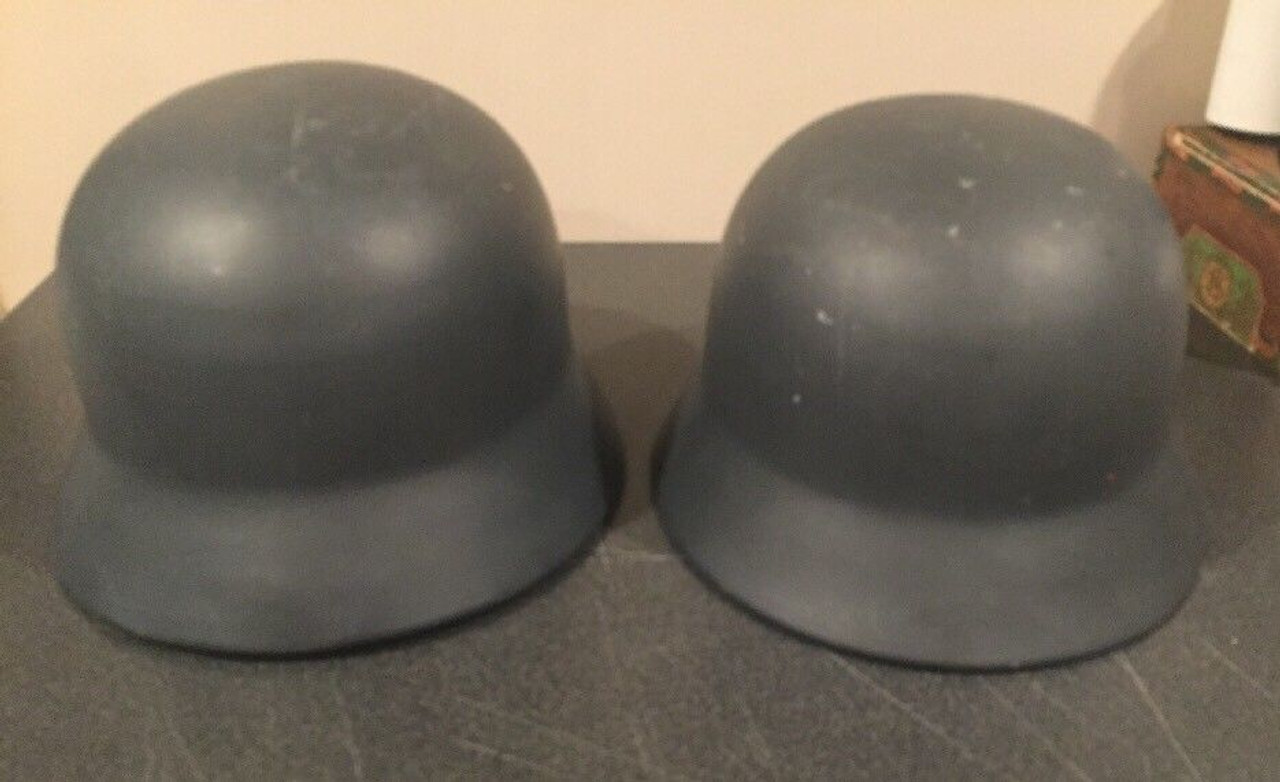 Pair of metal reproduction German military helmets with liners