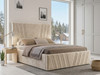 A luxurious extra-high headboard bed frame upholstered in pale cream smooth velvet.
