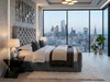 Elegant grey velvet Elena Ottoman bed frame featuring classic button tufting, showcased in a contemporary luxury penthouse apartment