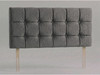 Tessera bed headboard in Steel Grey Atlanta fabric with a grid of padded squares, matching fabric buttons and wooden fixing struts