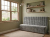 Elegant grey velvet dining booth seating featuring tailored fluted accent lines.