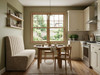 Luxurious beige velvet fluted dining booth seating in a modern dining room.