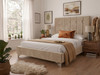 Constance Upholstered Bed Frame in warm beige velvet fabric, highlighting the luxurious deep-buttoned tufted headboard and sleek low footboard