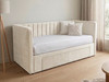 This image illustrates an upholstered Basil Day Bed in pale cream velvet, displaying a strong, British-made frame with a chic fluted backrest and a compact, space-saving design.