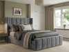 Luxurious grey velvet Martina Ottoman bed frame featuring a tall winged headboard with fluted vertical accents.