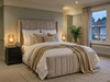 Carla Ottoman storage bed frame upholstered in premium beige velvet, featuring a tall vertical fluted winged headboard.
