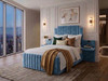 Ottoman Storage Bed Frame upholstered in luxurious sky blue velvet, featuring a bespoke stepped headboard with vertical fluted panels and built-in bedside table