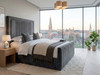 Full view of the handcrafted Eva Ottoman bed frame in luxurious grey velvet, highlighting the heavy-duty triple-reinforced frame and contemporary high footboard