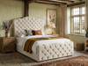 Melibea Ottoman Storage Bed Frame upholstered in soft cream velvet, showcasing a luxurious curved camelback headboard and tufted footboard