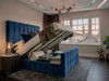 Open storage view of the blue velvet Tarja Ottoman Bed, with the front-opening mechanism raised to show the practical, solid-base storage space underneath
