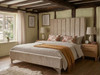 Zofia upholstered bed frame in warm beige velvet fabric, showing a contemporary tall headboard with deep vertical fluted detailing