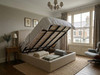 Melina Sand Velvet ottoman storage bed frame lifted open showing the deep under-bed storage compartment and solid base boards