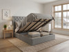 Functional ottoman storage bed in silver smooth velvet, with the mattress base lifted by hydraulic gas struts to reveal the expansive underbed storage area and internal frame.