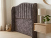 showing the deep fluted vertical lines and plush texture of a marble grey velvet headboard.
