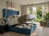 Oksana wingback ottoman bed in teal boucle with gas-lift storage open, showing the storage space underneath
