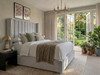 Oksana wingback ottoman bed in grey velvet with deep fluted headboard and gold accent strips