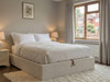 Lena ottoman storage bed base frame in ivory velvet fabric, front view, heavy-duty flat pack bed made in Birmingham UK by Hush My Bed